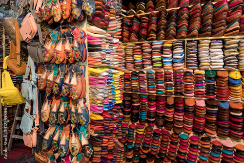 The traditional handmade leather handbag and slippers and other product is displayed in the tannery and showroom in the souk of Fes. Morocco © Michal