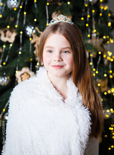 Portrait of a cute little princess in Christmas lights