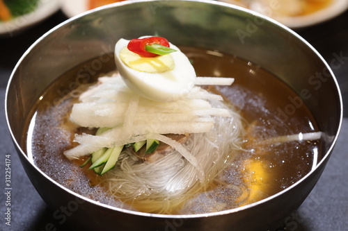 달걀과 배 등 다양한 야채들이 어우러진 한국의 음식 물냉면(naengmyeon) photo