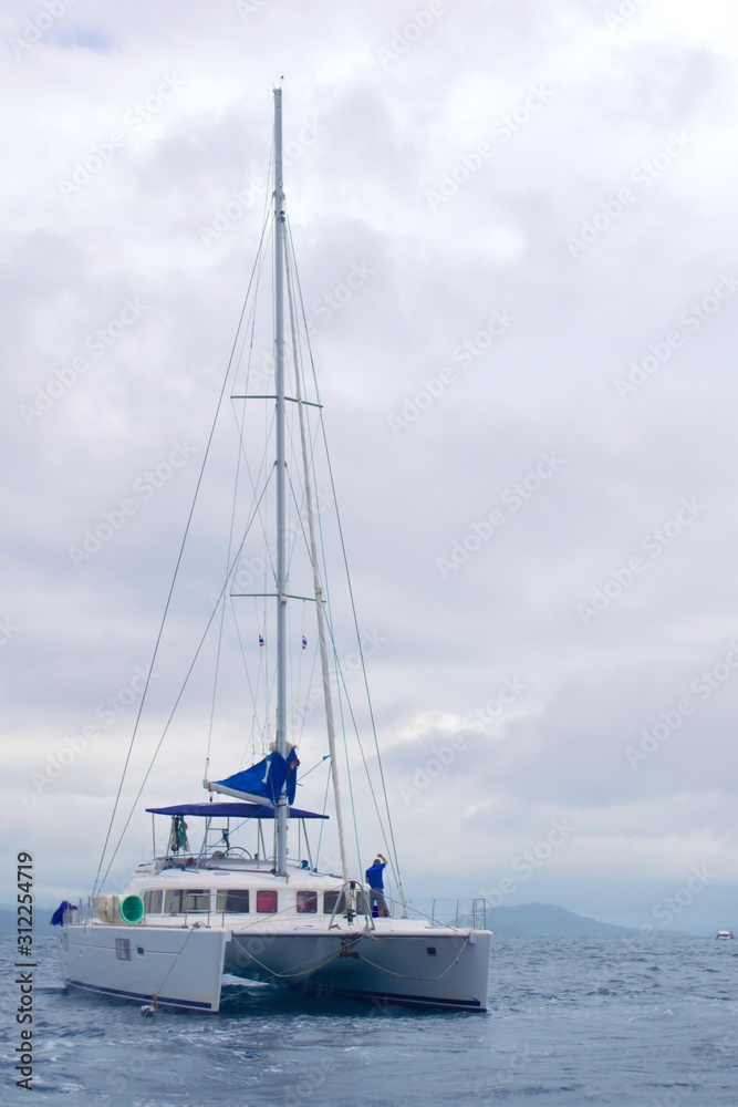 Leisure sail catamaran anchored off the coast of Phuket, Thailand.