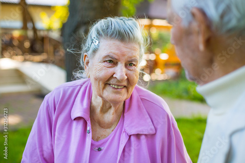 Romantic grandparents 90 years old. Two caucasian senior citizens are embracing each other. Elderly couple marriage  in love
