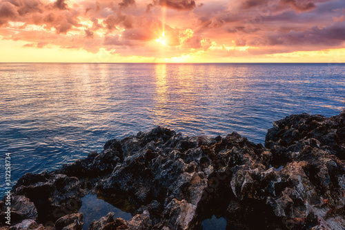 Amazing colorful sunrise over the sea and rocks  scenic seascape  Cavo Greko  Ayia Napa  Cyprus. Outdoor travel background