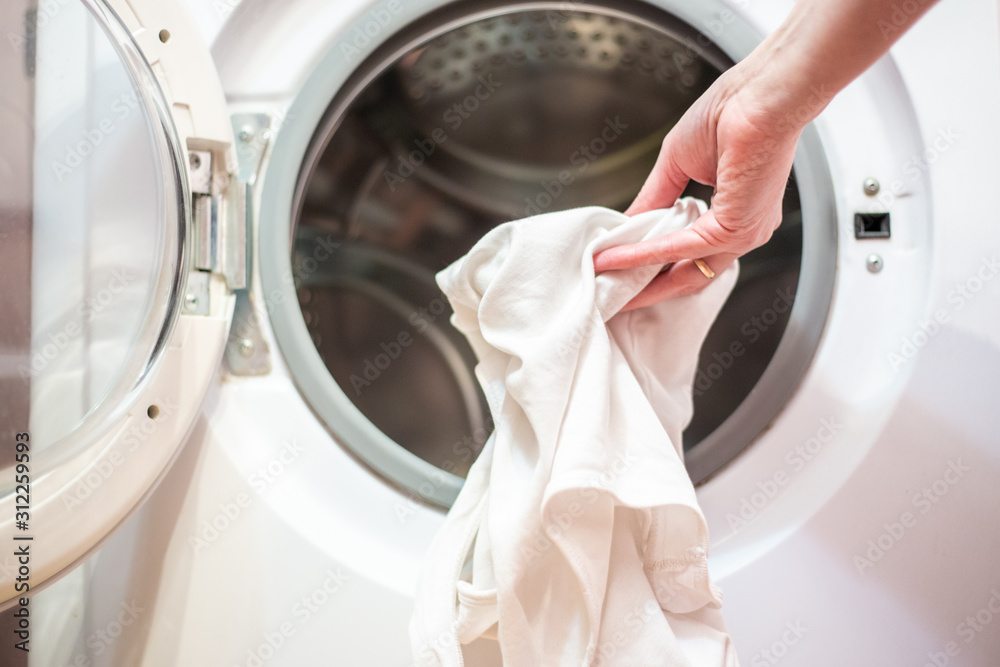 open door of the washing machine with dirty laundry open door of the washing machine with dirty laundry