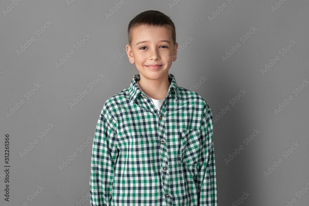 Freestyle. Boy standing isolated on grey wall smiling joyful Freestyle. Boy standing isolated on grey wall smiling joyful
