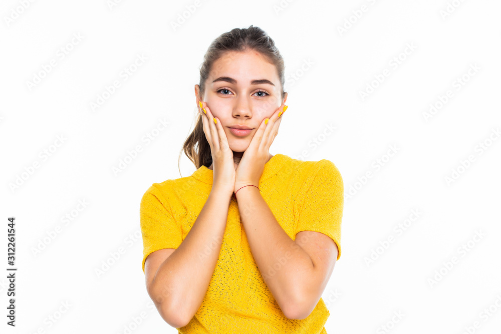 Head shot portrait grateful hopeful young teen girl holding hands on chin, pleased young female looking at camera, feeling love, gratitude, appreciation, thanking fate, isolated on studio background Head shot portrait grateful hopeful young teen girl holding hands on chin, pleased young female looking at camera, feeling love, gratitude, appreciation, thanking fate, isolated on studio background