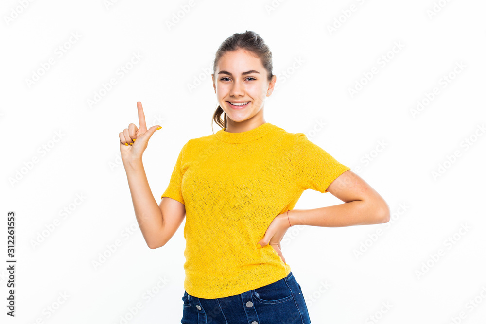 Portrait of a happy casual girl pointed up against white background Portrait of a happy casual girl pointed up against white background
