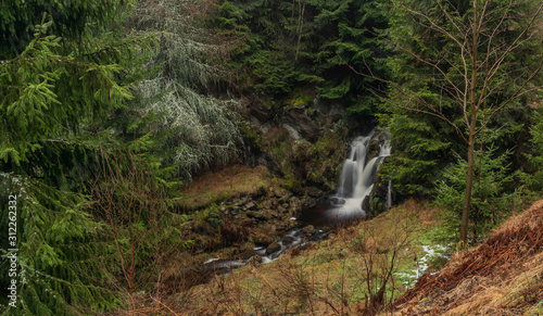 Waterfall of Chomutovka river near Chomutov town in winter morning photo
