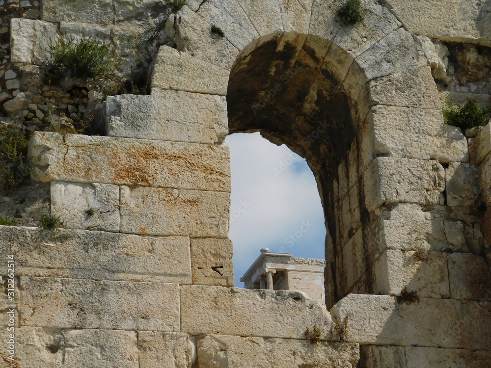 The temple of Athena Nike, on the Acropolis, seen through an arch of the Odeon of Herodes Atticus, or Herodeon, in Athens, Greece