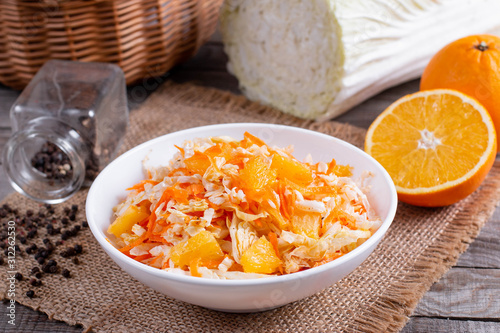 Fresh cabbage salad with oranges and carrots