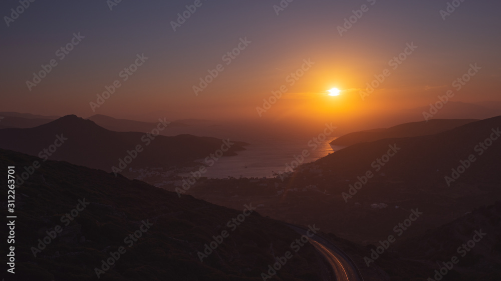 sunset over the bay with the port in Amorgos