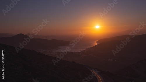 sunset over the bay with the port in Amorgos © s-top