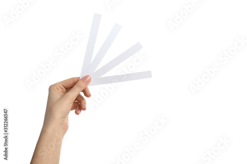 Woman holding perfume testing strips on white background, closeup photo