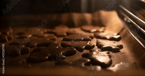 Gingerbread cookies in the oven. Soft warm light, selective focus