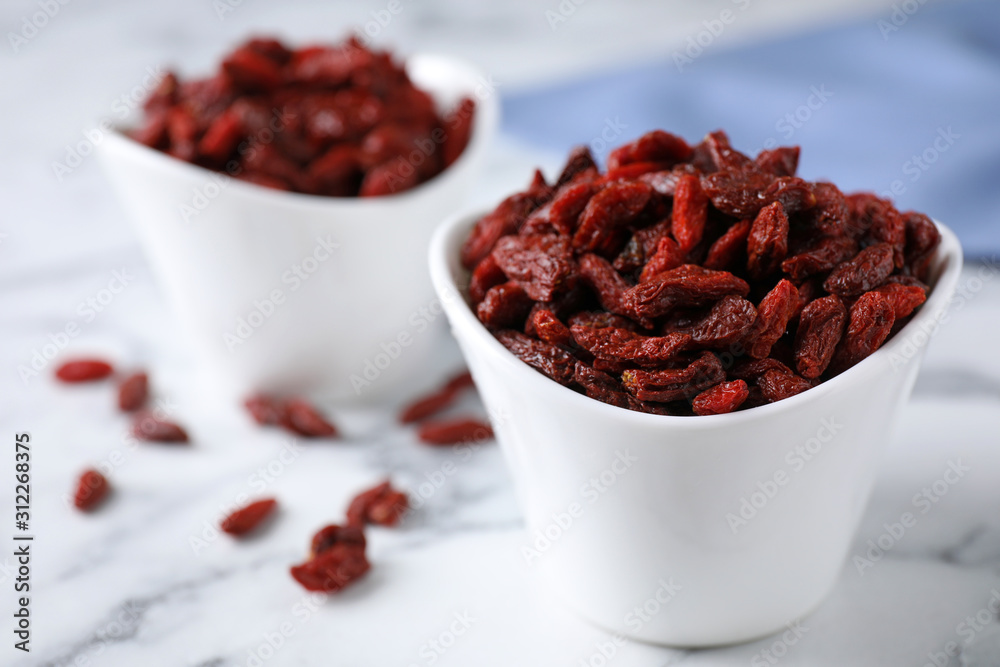 Dry goji berries on marble table, closeup Dry goji berries on marble table, closeup
