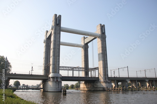 vertical lift bridge of concrete over river Gouwe in Gouda for trains named Gouwespoorbruggen in the Netherlands