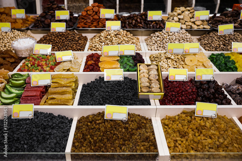 Assortment of delicious dried fruits and nuts at wholesale market