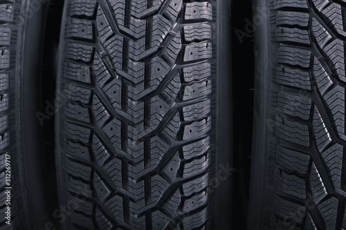 Black car tires as background, closeup. Auto store