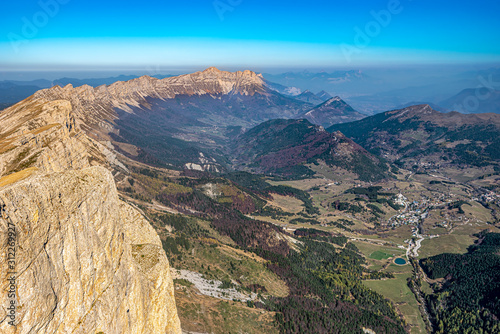 Fototapeta Ridges of Vercors as seen from Grand Veymont mountain summit, dominating the valley of Vercors Regional Natural Park and Gresse-en-Vercors village