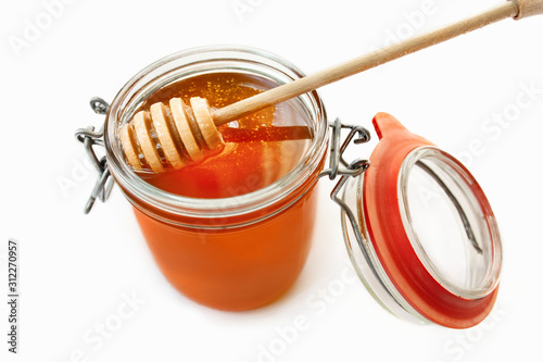 Jar with honey on a white background