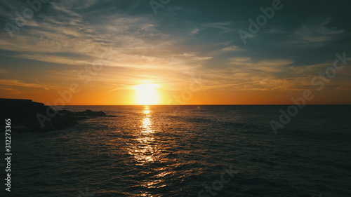 Landscape and sunset on the coast contemplating the breaking of the waves on the cliffs