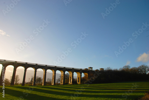The sun casting long shadows at the Balcombe Viaduct across the River Ouse in Sussex, England
