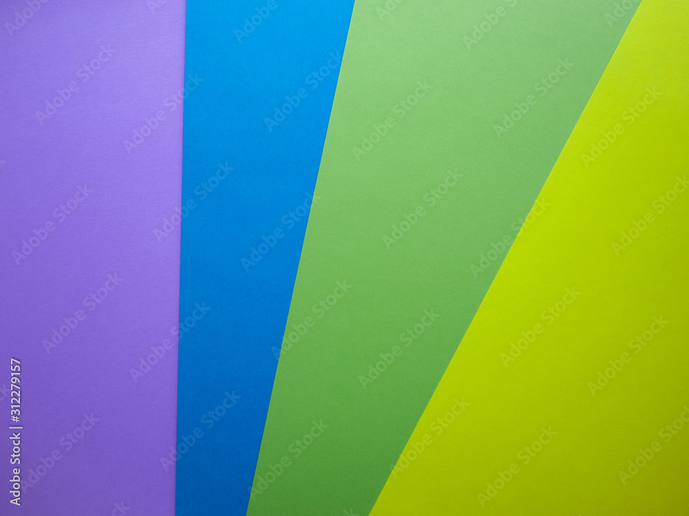Different colors paper top view abstract background. Violet, blue, green and yellow cardboard paper sheets. Different colors paper top view abstract background. Violet, blue, green and yellow cardboard paper sheets.