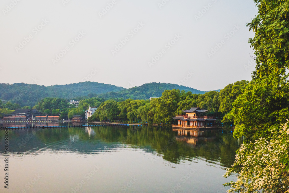 West Lake landscape with reflections in water at sunset, Hangzhou, China