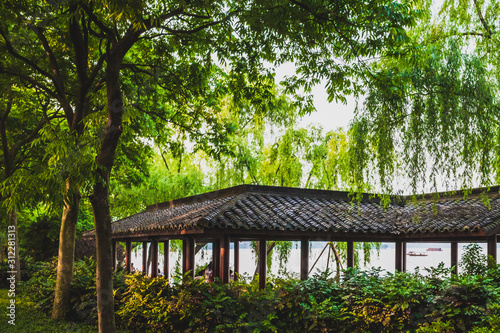 Traditional Chinese architecture among trees in park near West Lake  Hangzhou  China