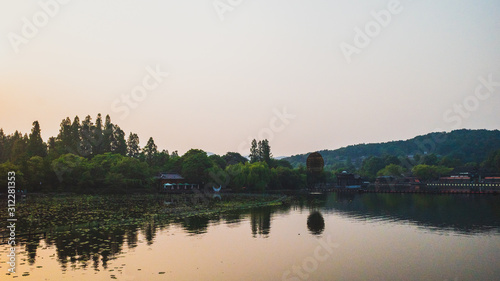 West Lake landscape with reflections in water at sunset, Hangzhou, China