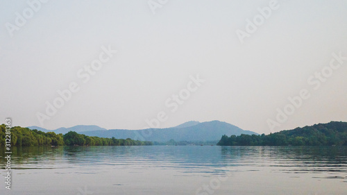 West Lake landscape with reflections in water at sunset, Hangzhou, China