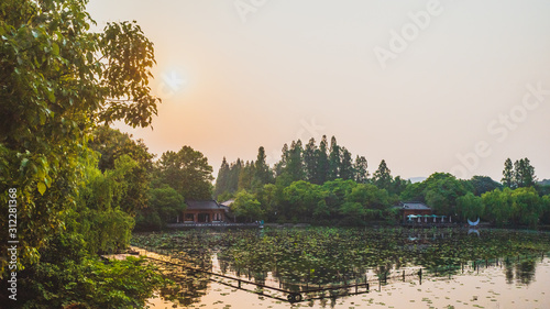 West Lake landscape with reflections in water at sunset, Hangzhou, China