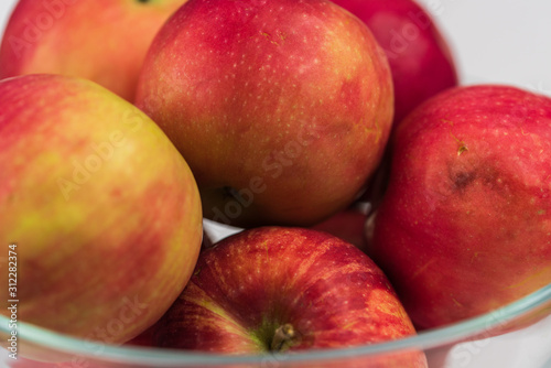 Apples in a clear glass bowl. 