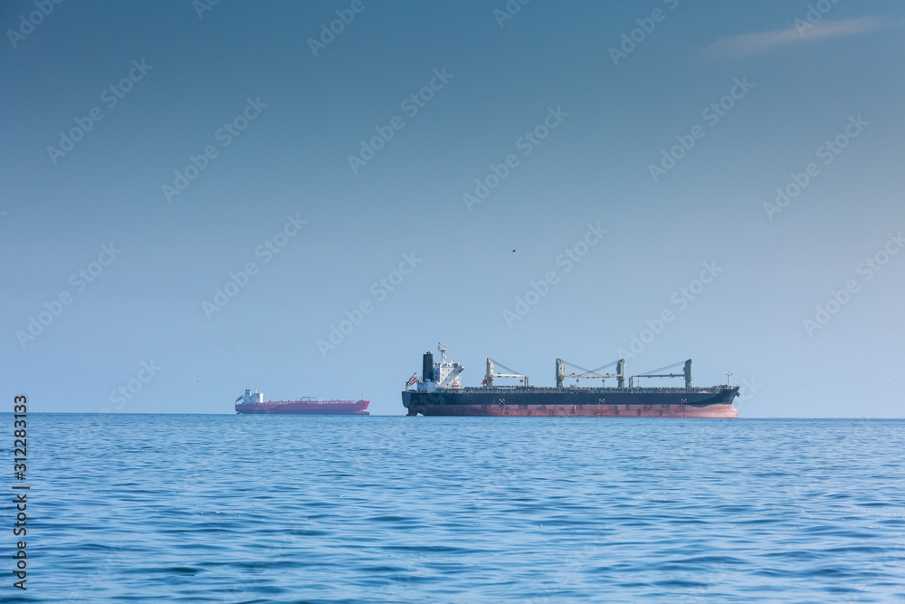 International trade concept. Two cargo ships on the high seas. International trade concept. Two cargo ships on the high seas.