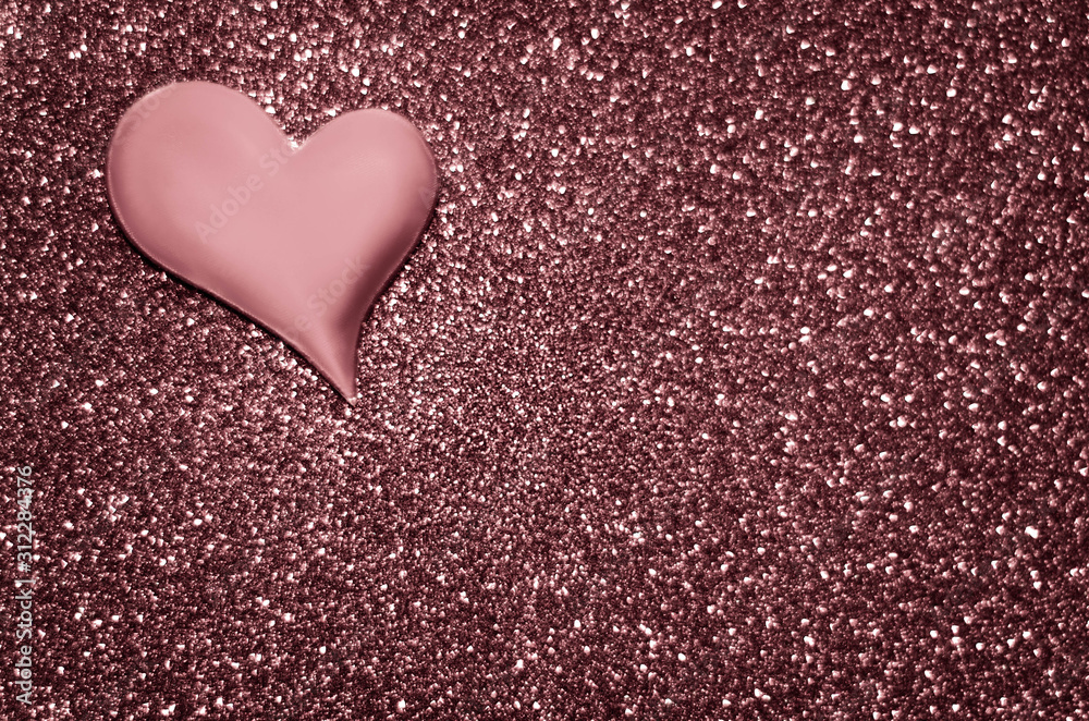 Satin dusty rose colour heart on a glittering background