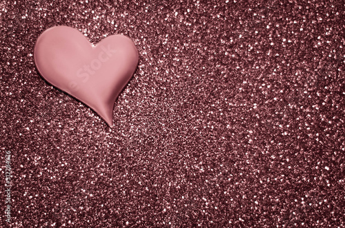 Satin dusty rose colour heart on a glittering background
