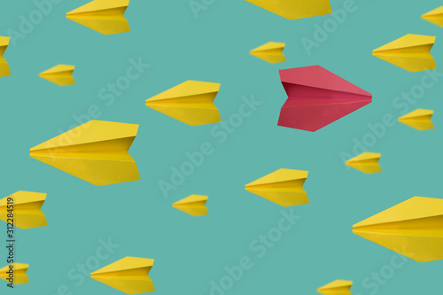 Red paper plane flying in different direction, think different concept © Sona