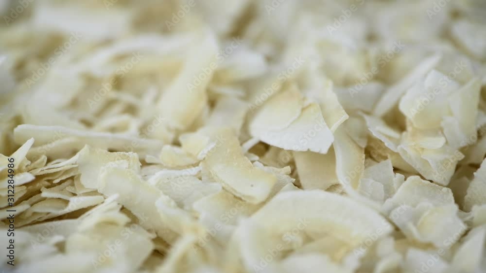 Rotating Coconut Chips as seamless loopable 4K UHD footage (close-up) Rotating Coconut Chips as seamless loopable 4K UHD footage (close-up)