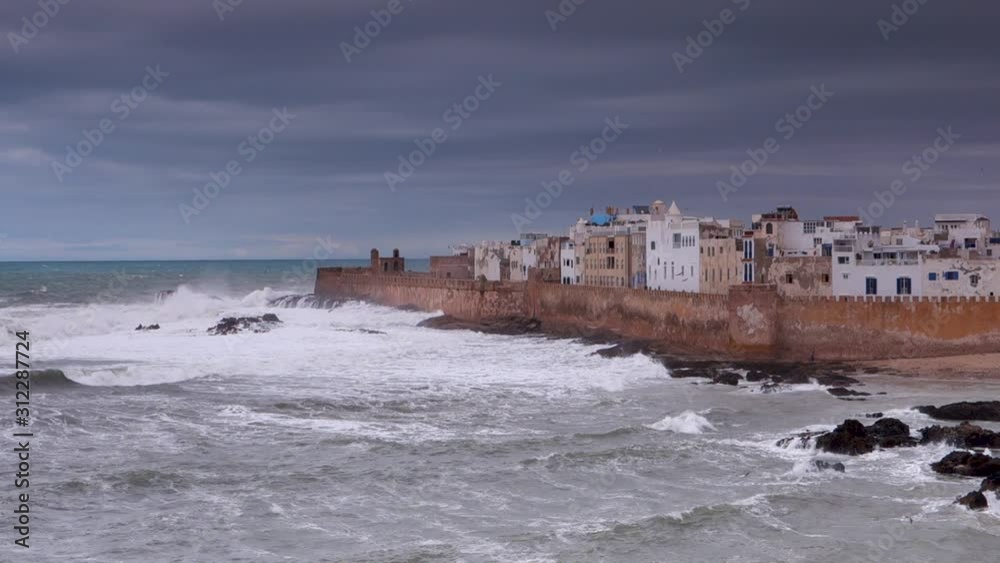 Medium shot of the city of Essaouira, Morocco during a dramatic storm shown in slow motion with the sea rolling in and the seagulls floating on the breeze. Medium shot of the city of Essaouira, Morocco during a dramatic storm shown in slow motion with the sea rolling in and the seagulls floating on the breeze.