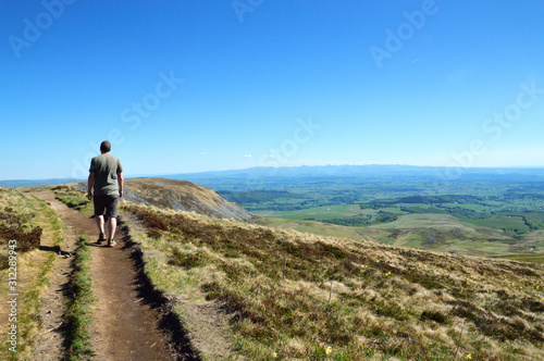 Hiker at the top of a volcano mountain on a hiking path