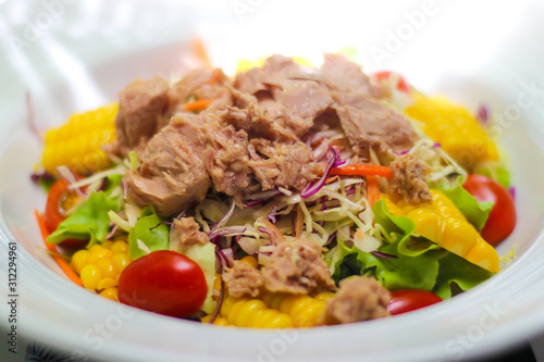Tuna salad with lettuce, corn and tomatoes.