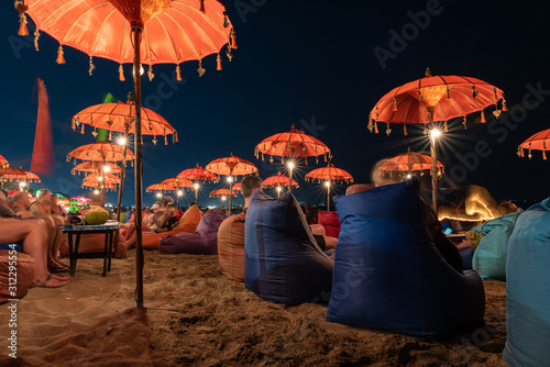 long exposure of the kuta beach bar chairs at night photo