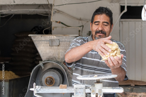 man selling dough in nixtamal mill photo