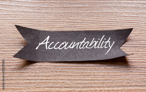 Fotografie Accountability word written on Black papper with wooden background