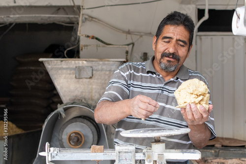 man selling dough in nixtamal mill photo