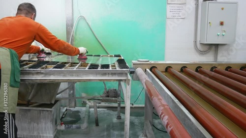 Manufacturing and fabrication of laminated glass.A working glass factory.