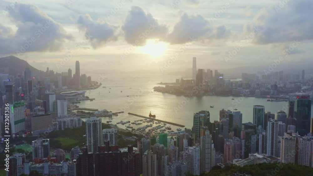 Aerial drone point of view over Hong Kong bay at evening time. Victoria Harbor, Hong Kong