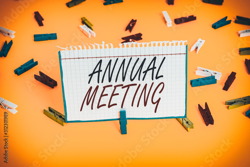 Writing note showing Annual Meeting. Business concept for yearly meeting of the general membership of an organization Colored clothespin papers empty reminder yellow floor background office