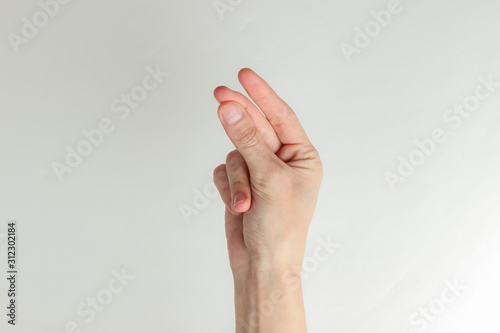 Female hand showing cash gesture (asking for money) on white background