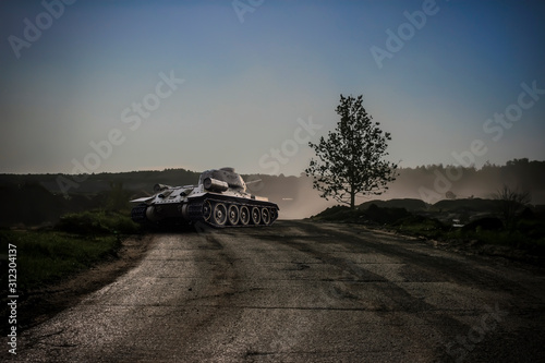 A rear view of a tank in a dry dusty atmosphere preparing to shoot photo