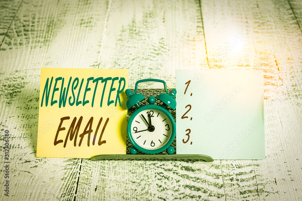 Conceptual hand writing showing Newsletter Email. Concept meaning email sent to subscribers informing them about the news Mini blue clock standing above buffer wire between two paper Conceptual hand writing showing Newsletter Email. Concept meaning email sent to subscribers informing them about the news Mini blue clock standing above buffer wire between two paper